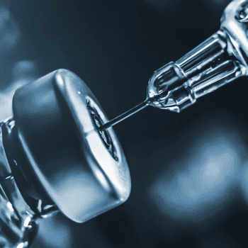 Detail of a syringe needle in a vial