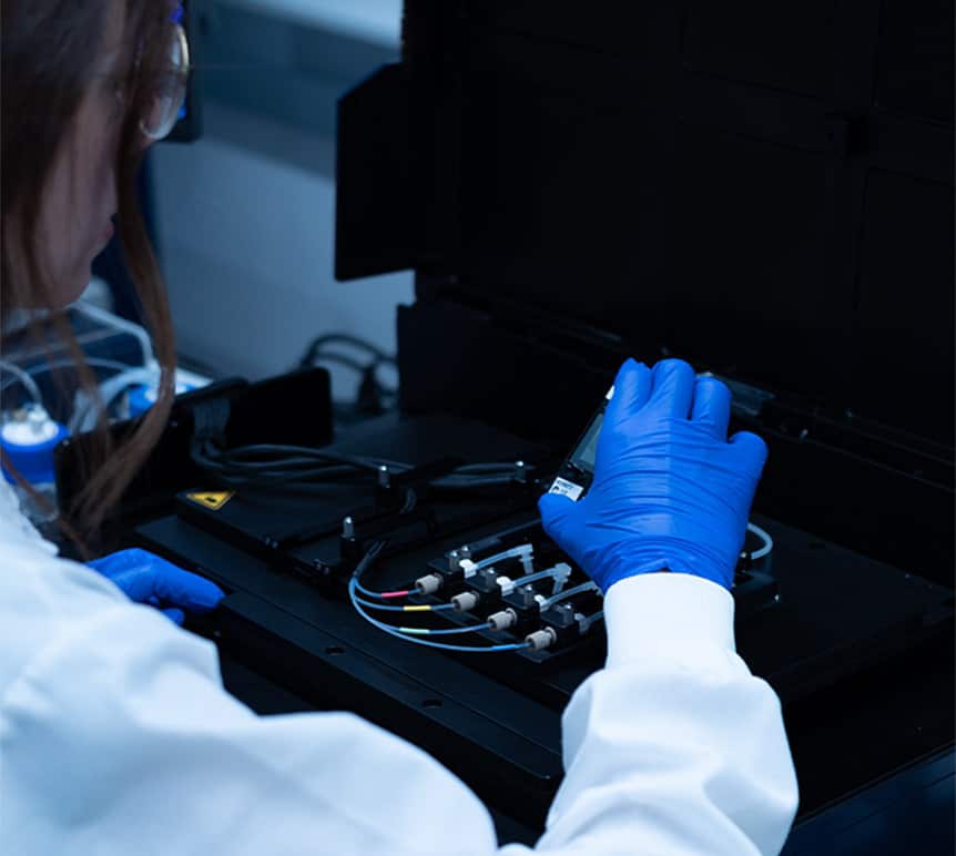 Scientist loading a chip into the CellScape instrument