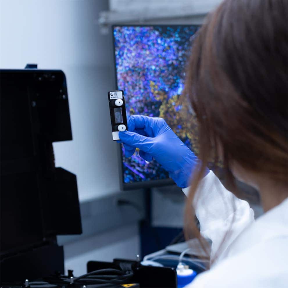 Female scientist holding a ChipCytometry chip