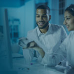 Researchers reviewing data on a monitor