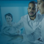 Researchers reviewing data on monitor